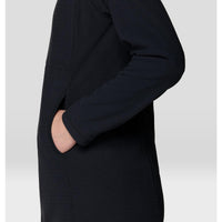 Side detail view of black grid-texture knit dress with hand pocket and ribbed cuffs