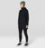 Women's long hooded fleece dress with kangaroo pocket, worn over black leggings, front-angled view