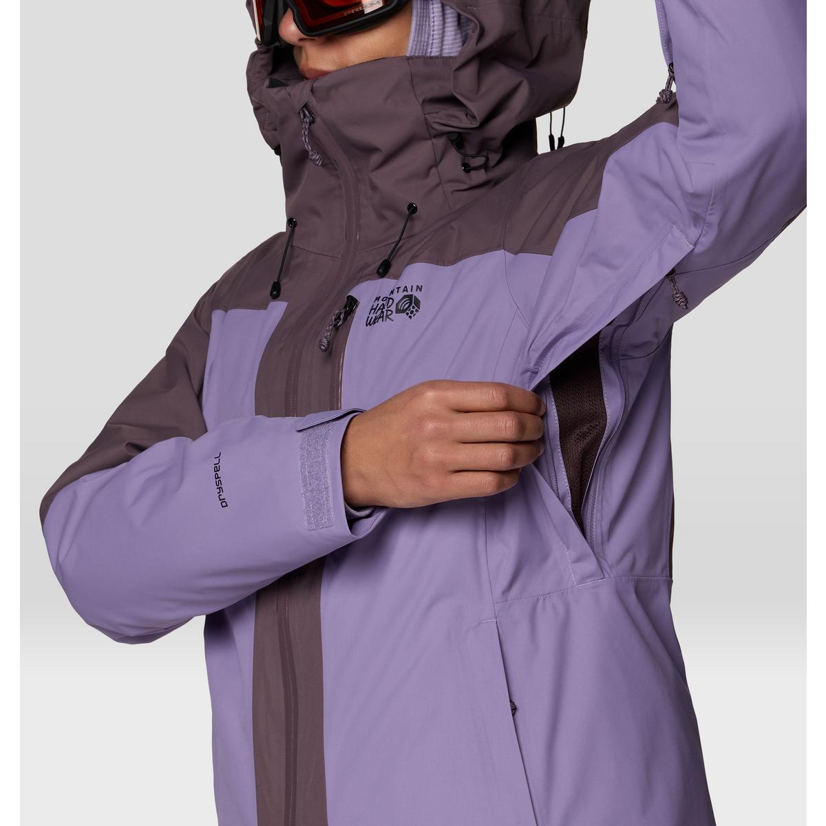 Close-up detail of women's ski jacket showing underarm vent zipper and DRYSPELL cuff label