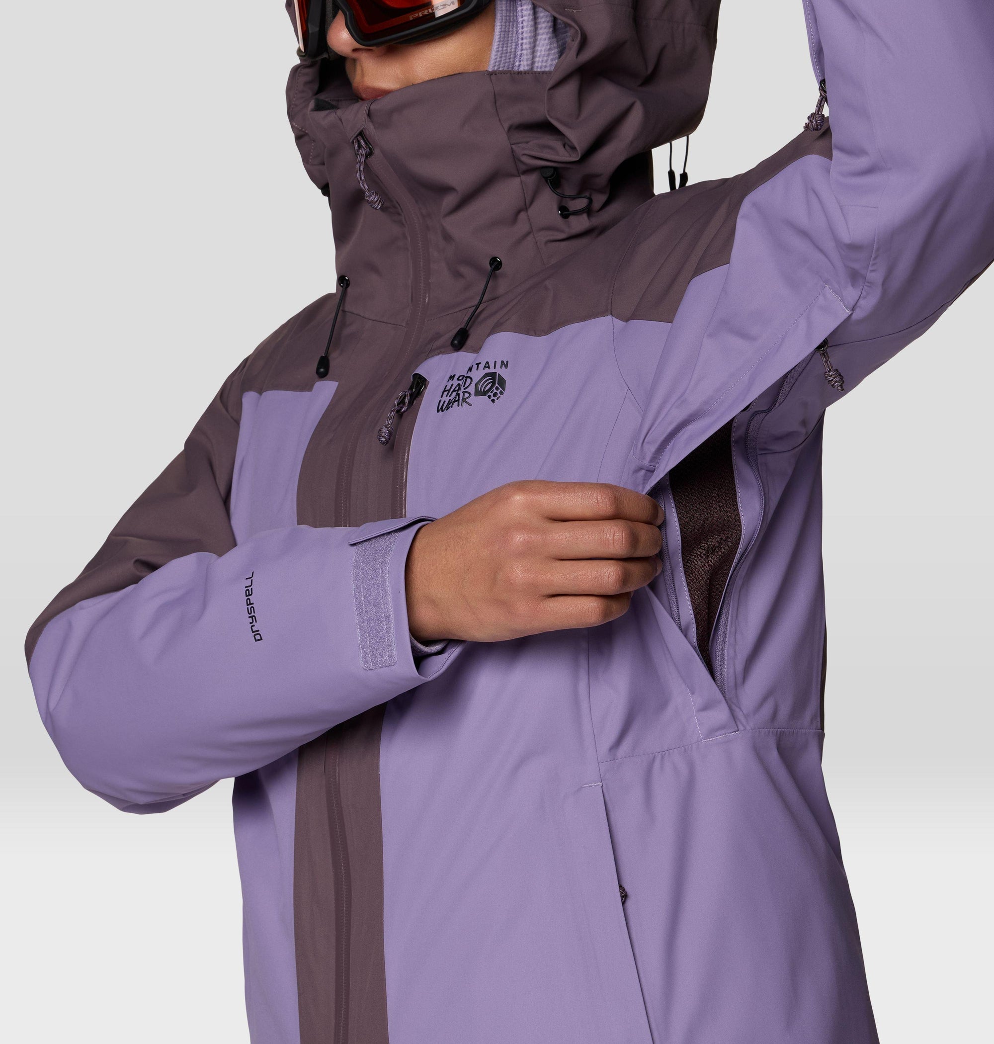 Close-up detail of women's ski jacket showing underarm zip vent and sleeve cuff with DRYSPELL label