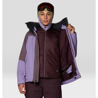 Women's ski jacket opened to reveal inner insulated vest layer, with ski goggles and hood, front view