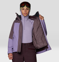 Women's insulated ski jacket open to show quilted lining, worn with matching base layer and goggles