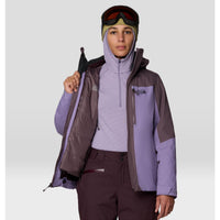 Women's insulated ski jacket shown open, revealing quilted inner layer, with hood and goggles