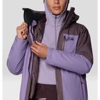 Women's insulated ski jacket detail shot showing open zipper, layering system, and chest pocket