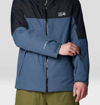 Two-tone waterproof hardshell jacket with black upper and blue lower, close-up front view showing zipper and cuffs