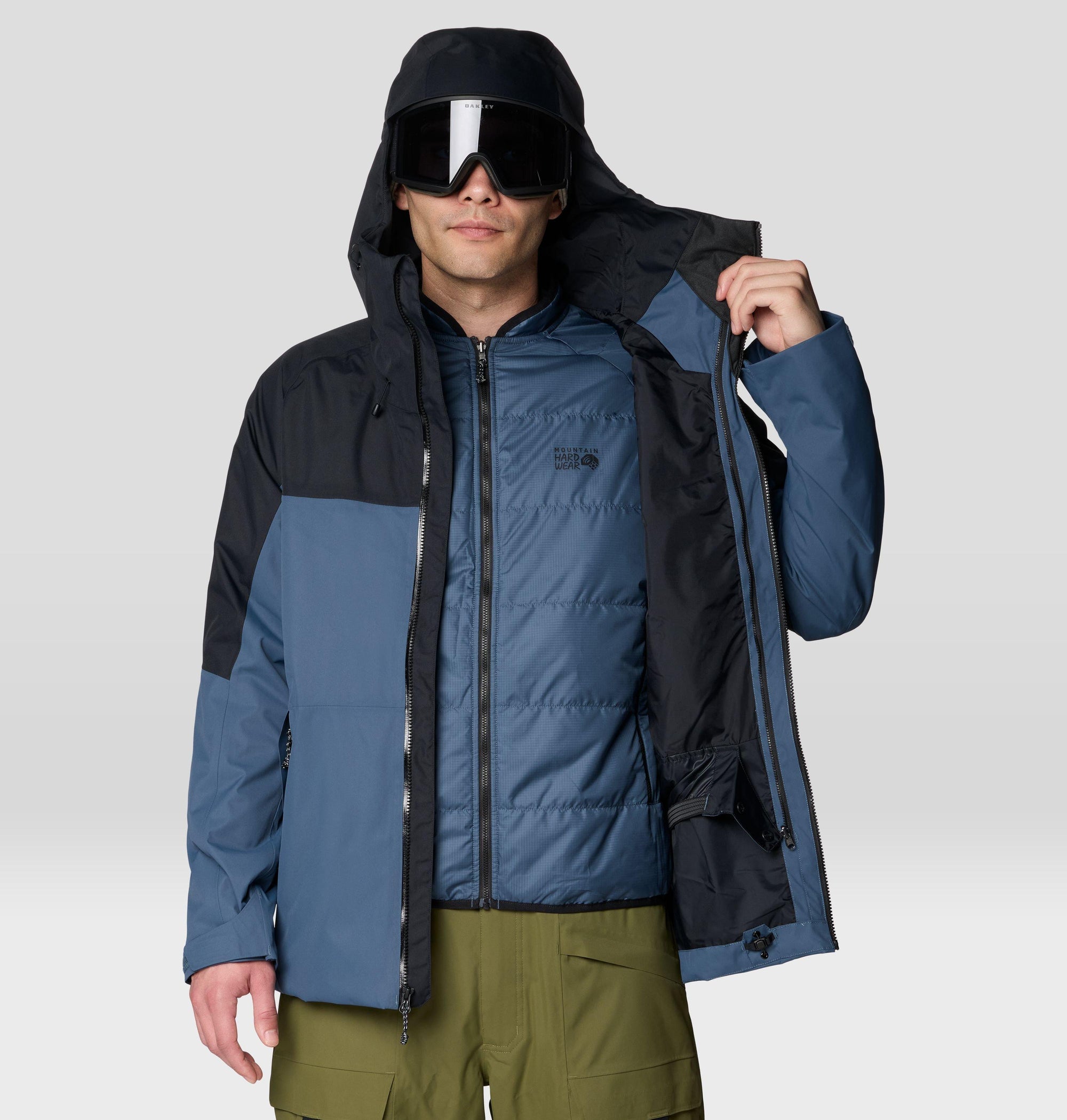 Men's hooded ski jacket opened to reveal insulated inner liner, two-tone blue and black colorblock design