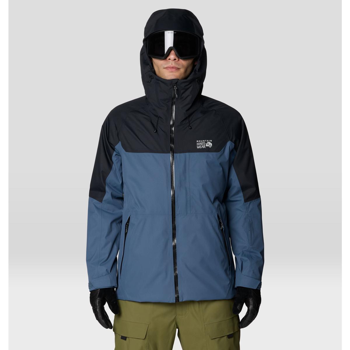 Men's hooded ski jacket with two-tone colorblock design, worn with goggles and gloves, front view