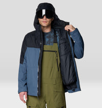 Men's insulated ski jacket open to show interior lining, worn with bib pants and ski goggles