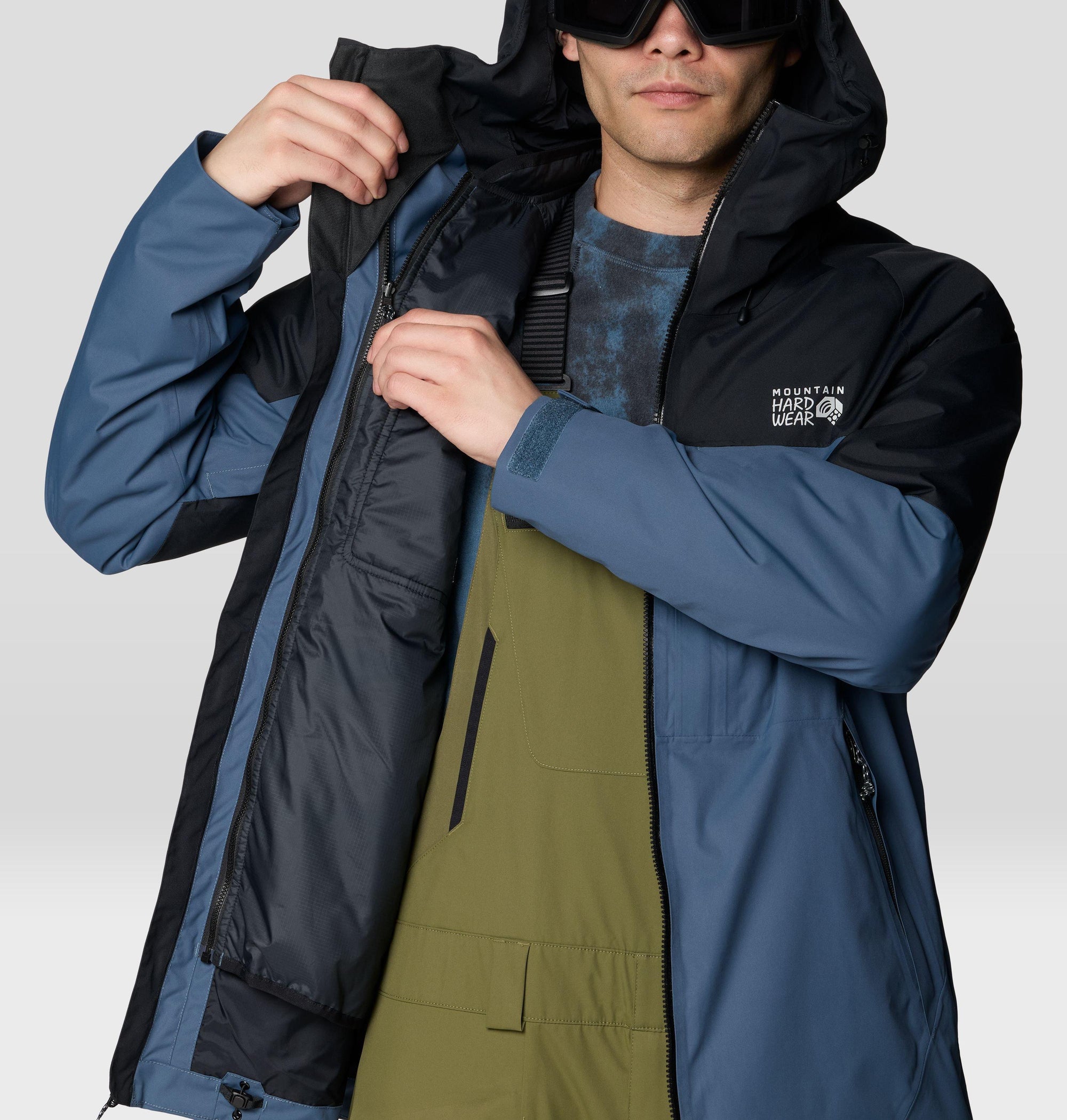 Men's hooded ski jacket open to show interior lining, detail close-up view