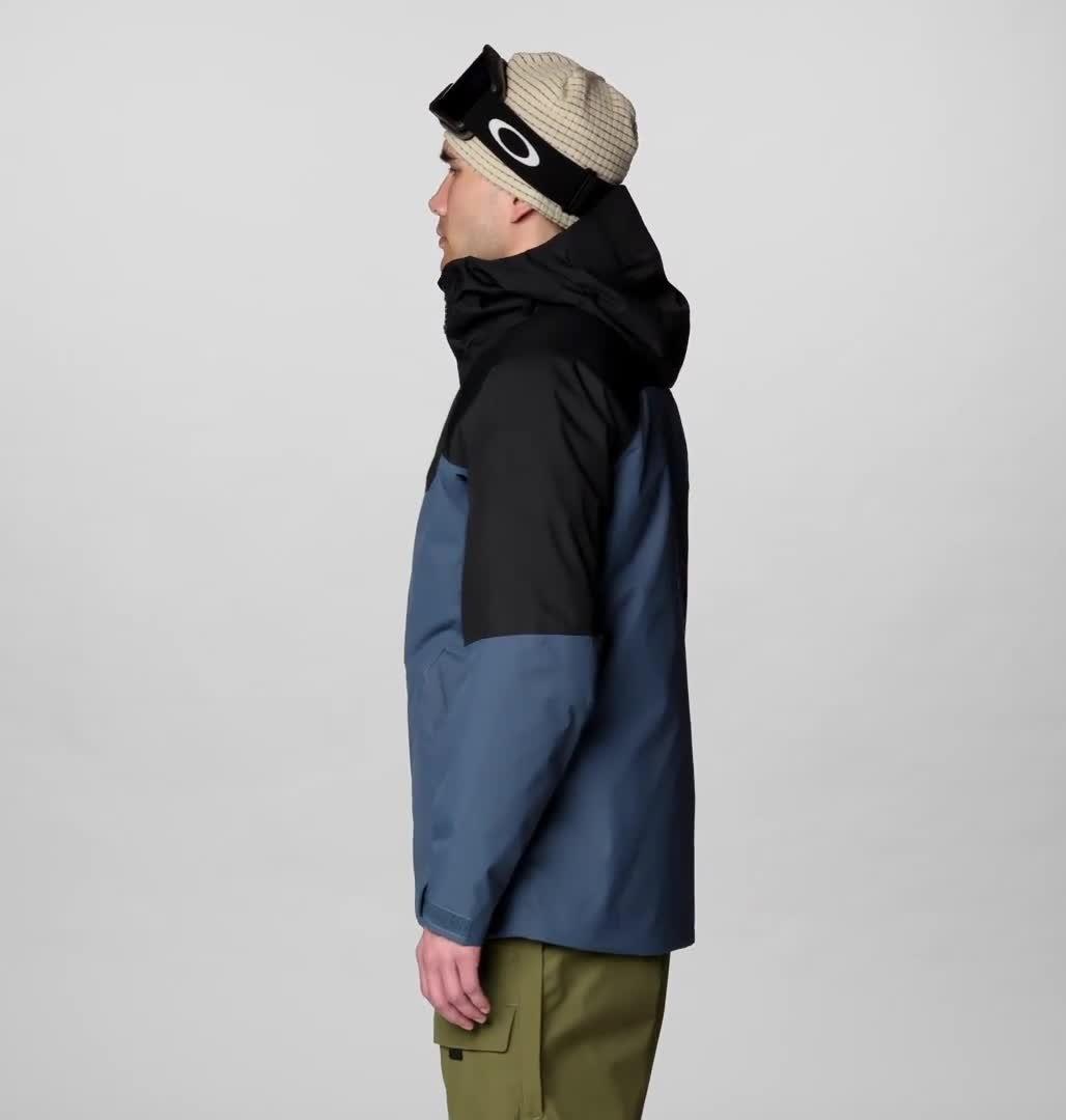 Men's insulated ski jacket side view, two-tone blue and black colorblock with helmet-compatible hood