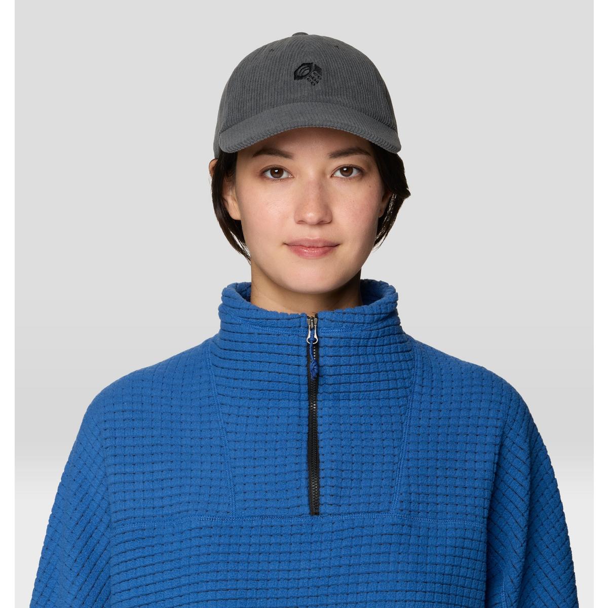 Dark gray corduroy dad cap with embroidered logo, worn on model, front view