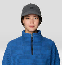 Dark gray corduroy dad cap with small logo, worn by model, front view