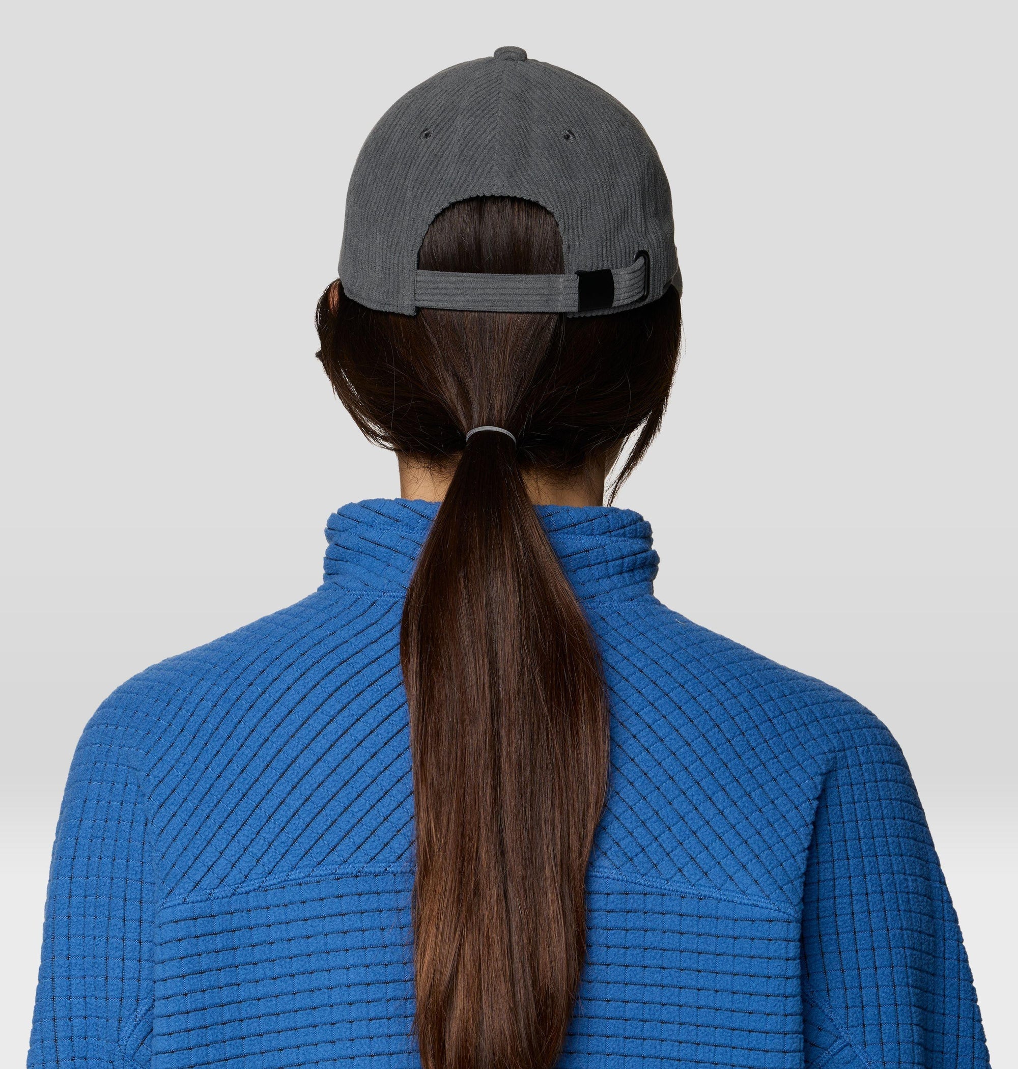 Corduroy baseball cap in dark gray, back view showing adjustable strap and ponytail opening