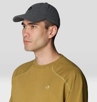 Dark gray corduroy baseball cap with small logo, worn on male model, side angle view