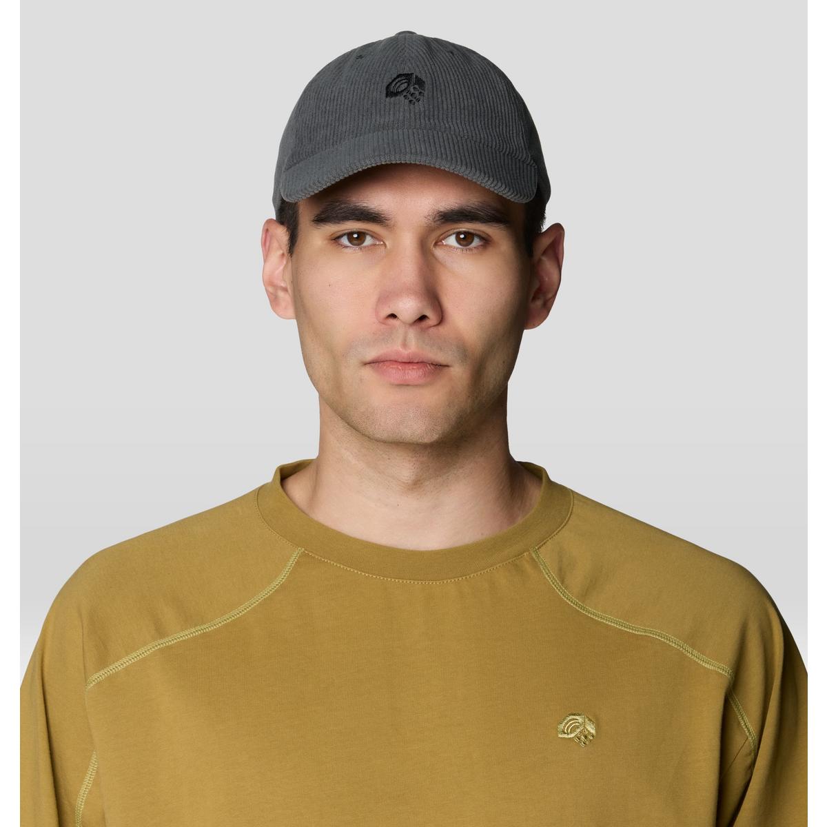 Dark gray corduroy baseball cap worn by male model, front view with embroidered logo