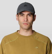 Dark gray corduroy dad cap with embroidered logo, worn on male model, front view