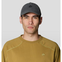 Dark gray corduroy baseball cap worn by male model, front view with embroidered logo