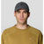 Dark gray corduroy baseball cap worn by male model, front view with embroidered logo