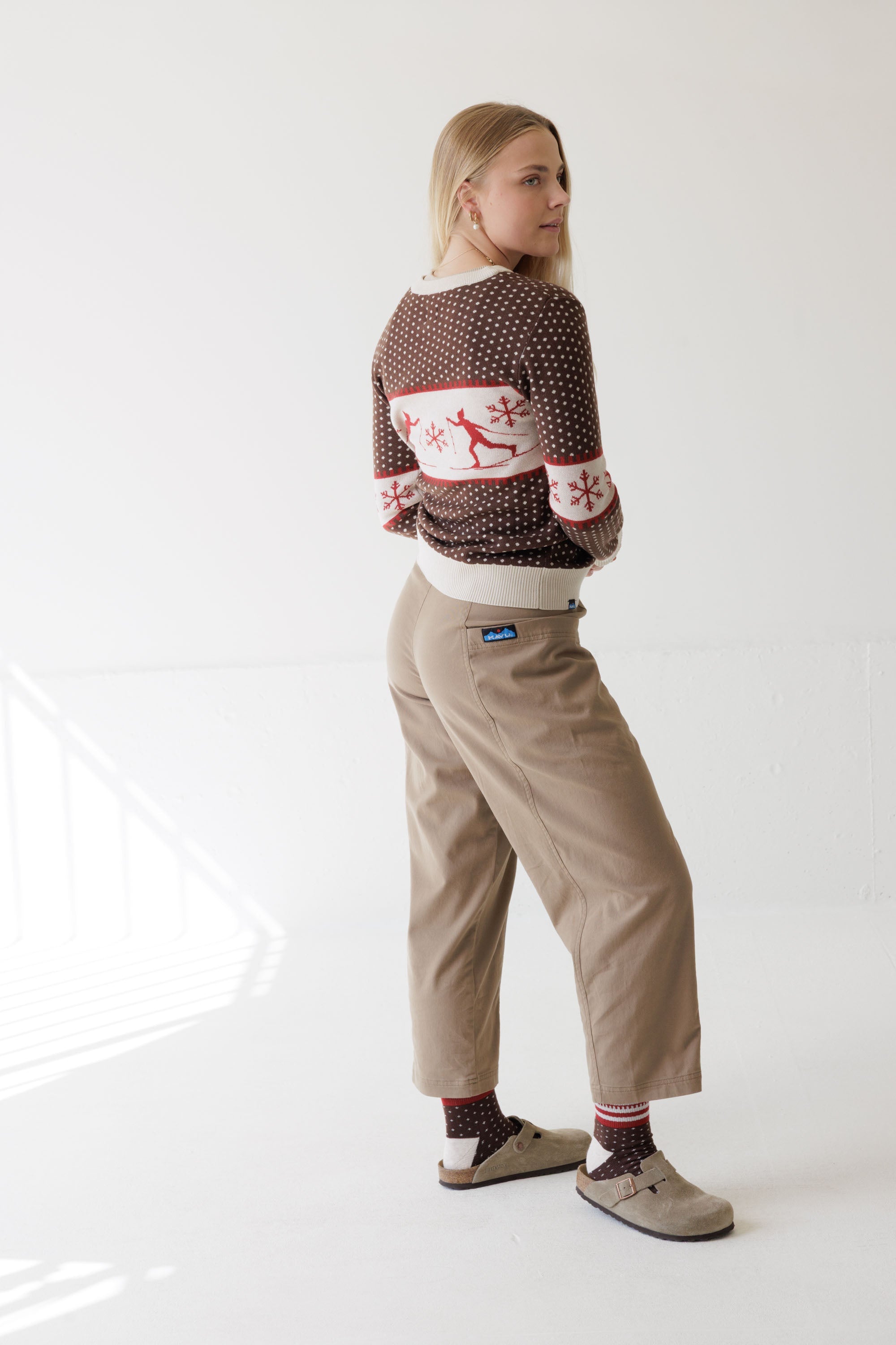 Women's Nordic-pattern pullover sweater with reindeer and snowflakes, back view on model