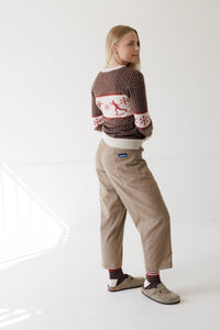 Women's Nordic-pattern pullover sweater with reindeer and snowflakes, back view on model