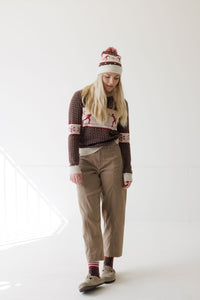 Women's Fair Isle ski-motif sweater in brown and cream with matching pom-pom beanie, front view