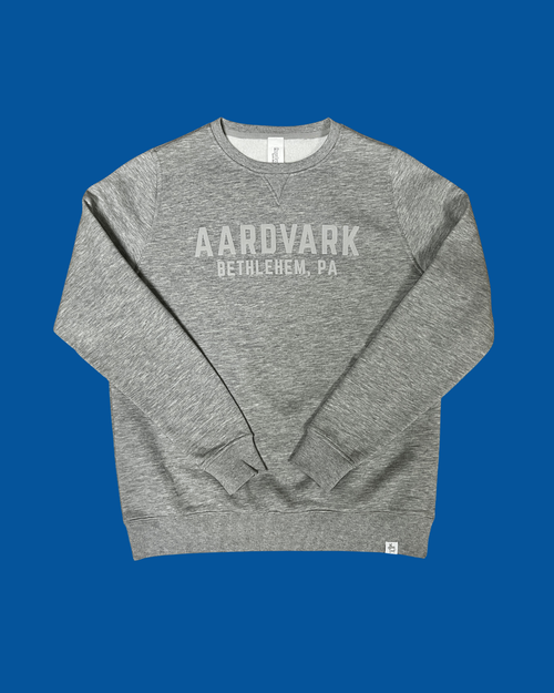 Grey heather crewneck sweatshirt with printed chest graphic, flat lay front view
