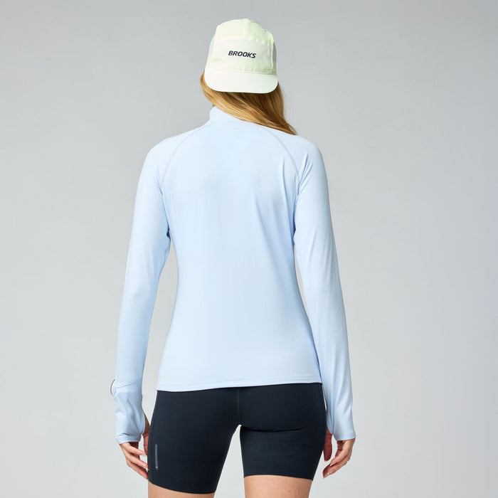 Light blue long-sleeve athletic shirt with half zip, shown from back view