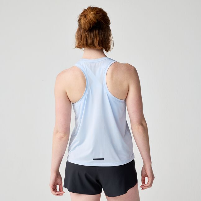 Light blue racerback tank top shown from behind on model with hair in bun