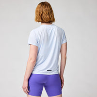 Light blue short sleeve athletic shirt shown from back, worn with purple shorts