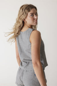 Gray ribbed sleeveless top with relaxed fit, worn by woman in three-quarter view