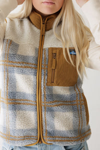 Women's sherpa fleece vest with plaid pattern, zip chest pocket, and corduroy trim, front detail view