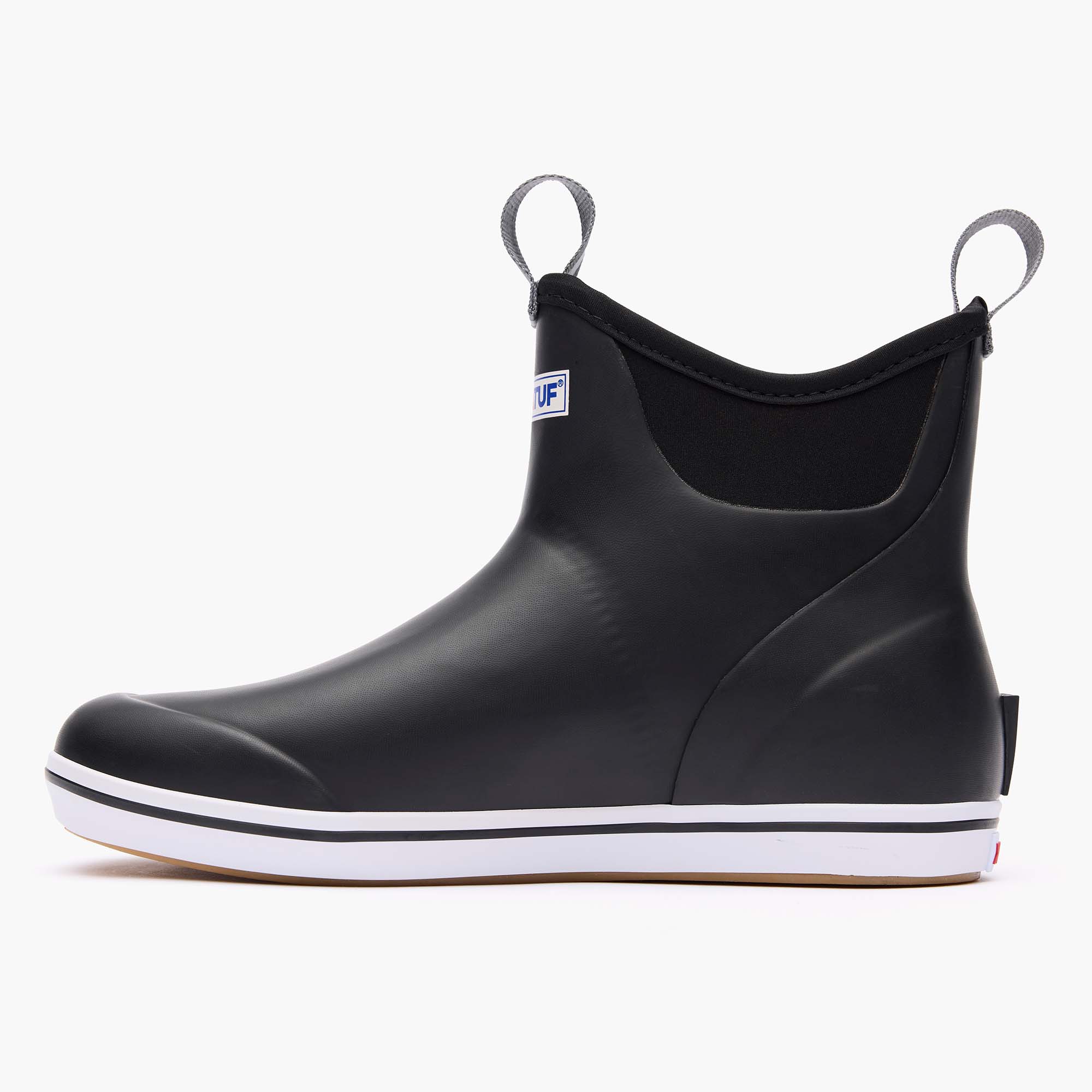 Black ankle deck boot with pull tabs, white sole, and elastic side panel, lateral view