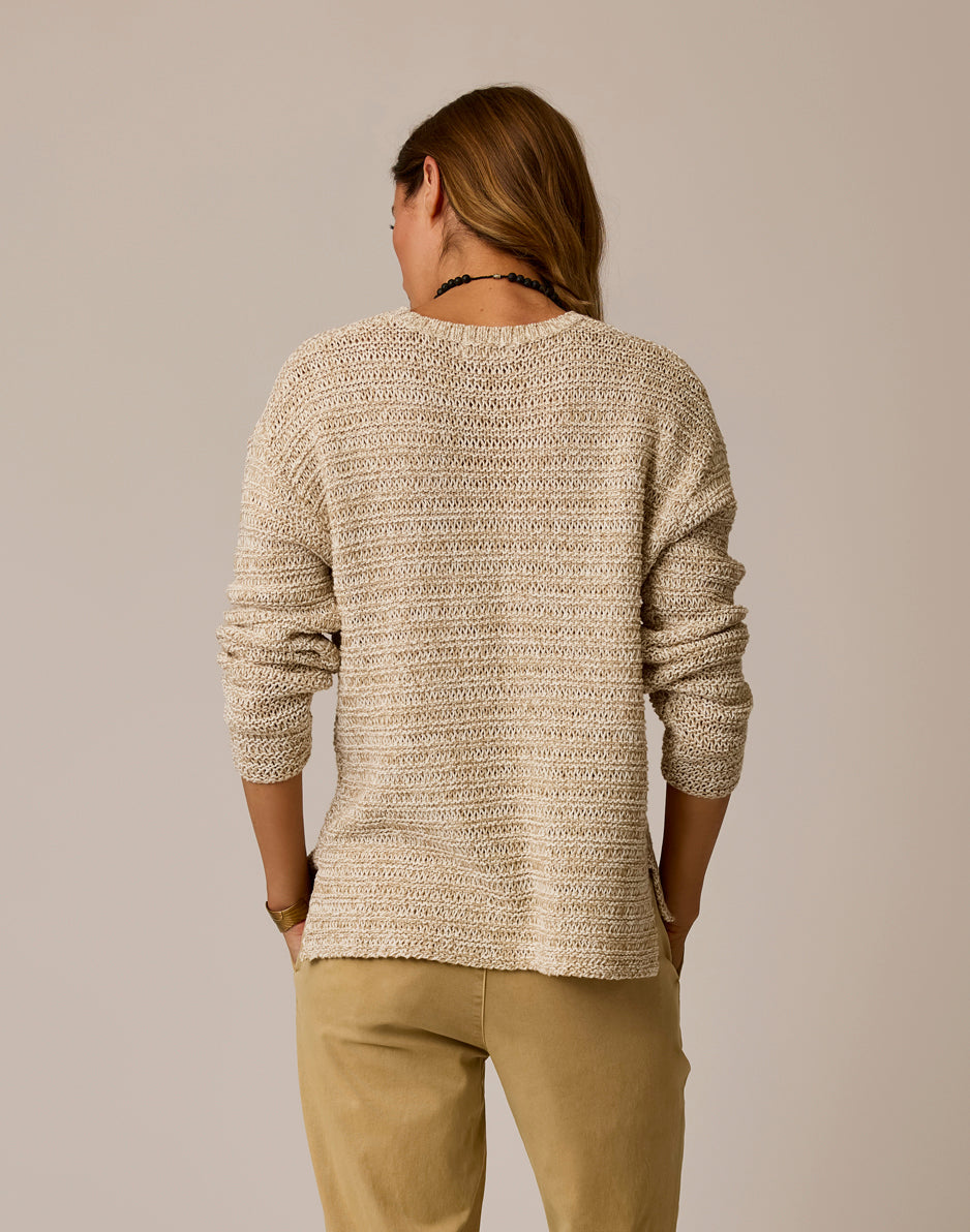 Woman wearing beige marled knit sweater, back view showing texture and fit