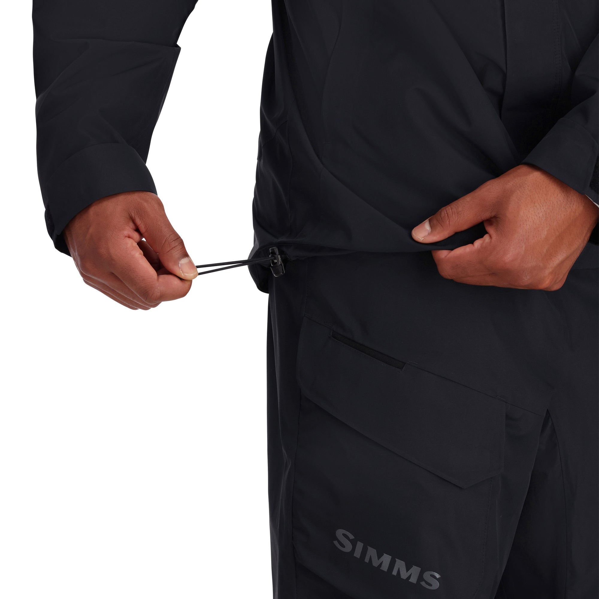 Black outdoor jacket with drawstring waist and zippered pocket, detail view of torso