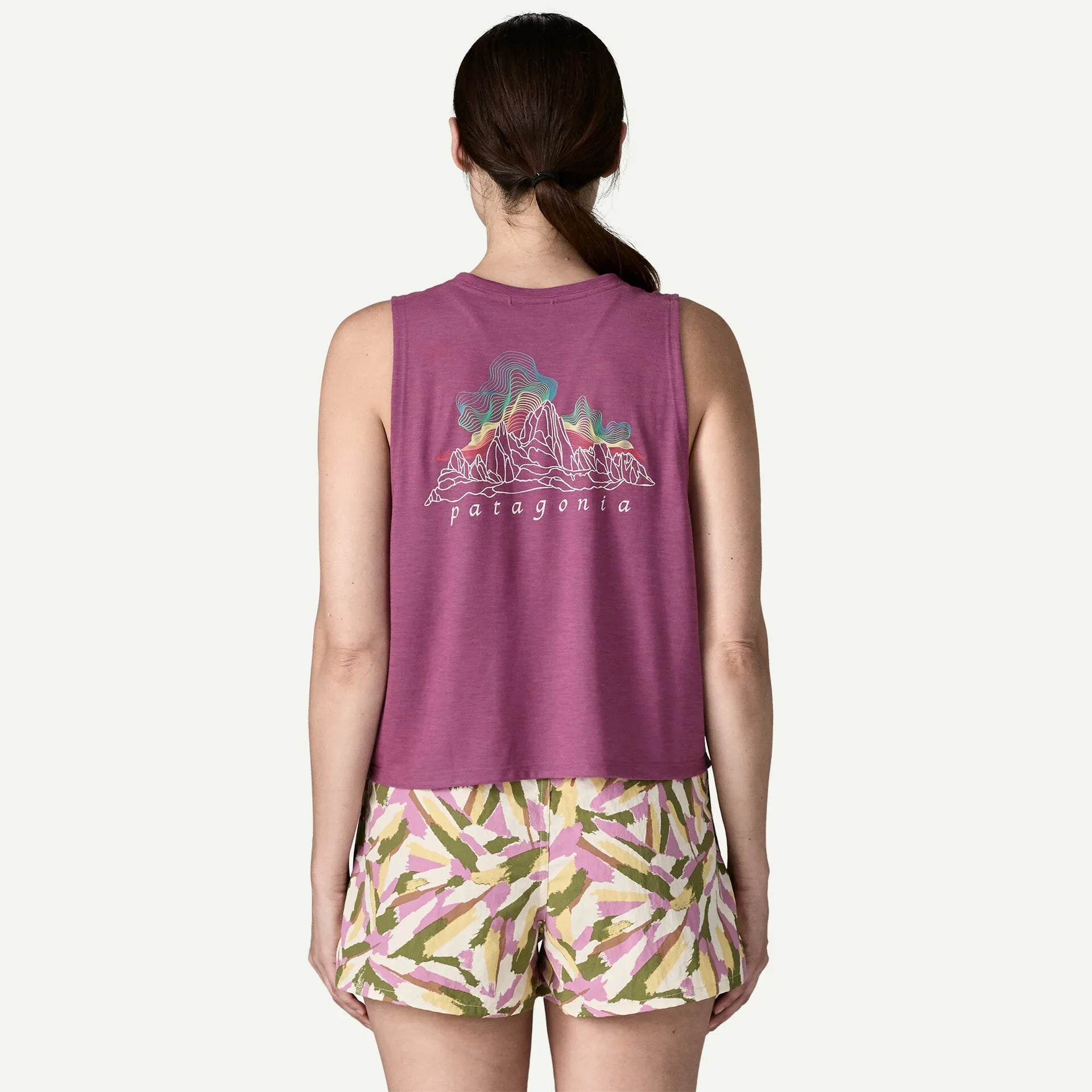 Purple sleeveless tank top with mountain graphic design, shown from back view on model