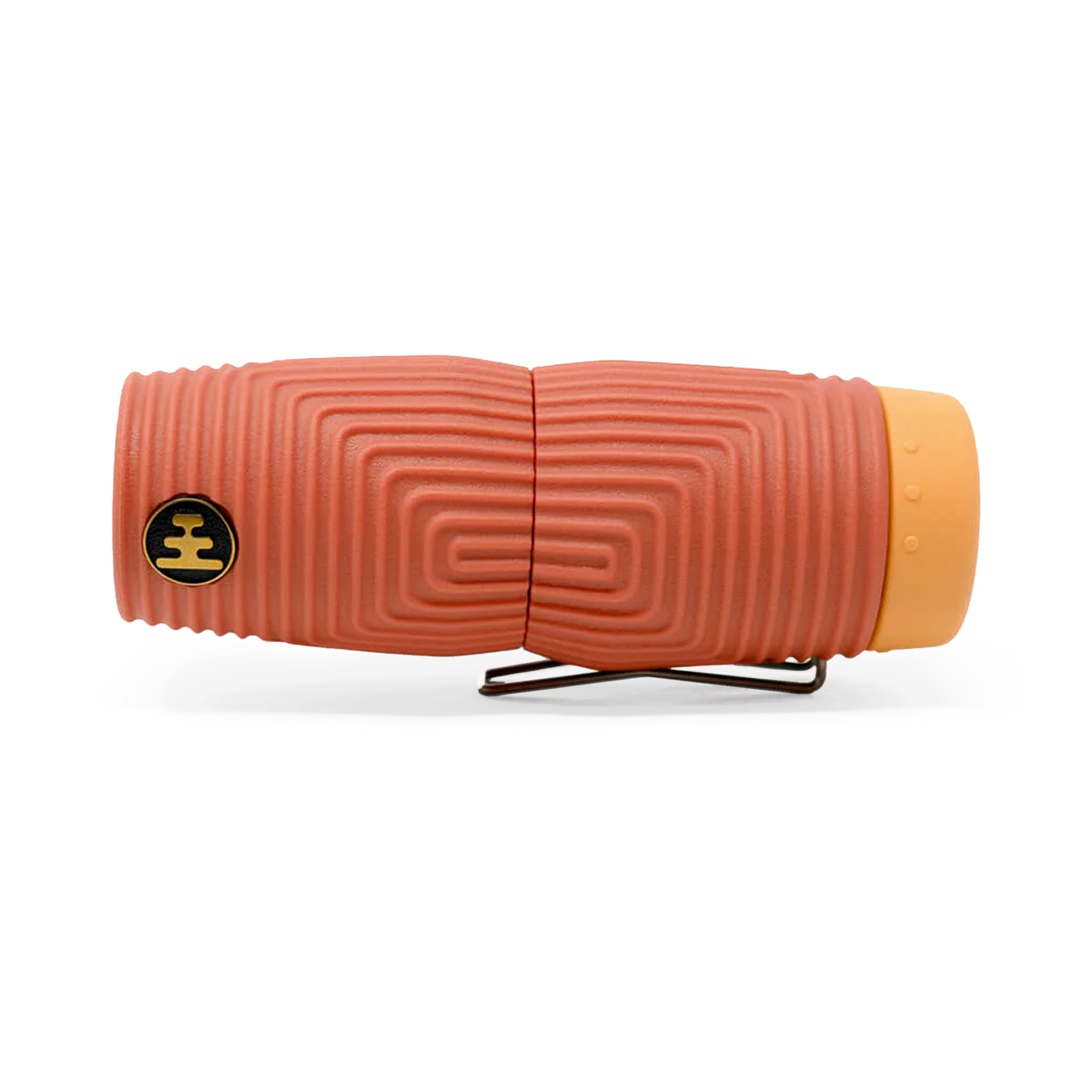 Compact monocular with textured terracotta body, spiral grip pattern, and orange eyepiece cap