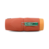 Compact monocular telescope with textured red rubber grip and orange lens cap, side view
