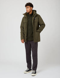 Men's olive green parka jacket with hood, chest pockets, and fleece lining, full-length front view