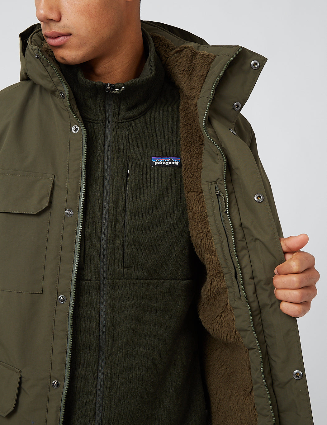 Men's parka jacket open to reveal sherpa fleece lining, detail close-up view