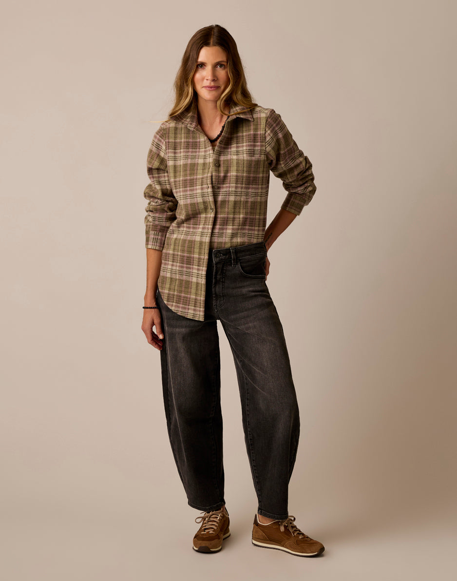 Women's plaid flannel button-up shirt in olive tones, full-length front view on model