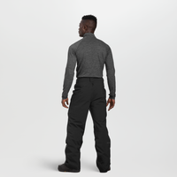 Men's black snow pants back view, worn with gray base layer, standing model