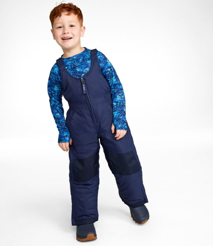 Child wearing navy insulated snow bib overalls with front zipper and reinforced knees, front view