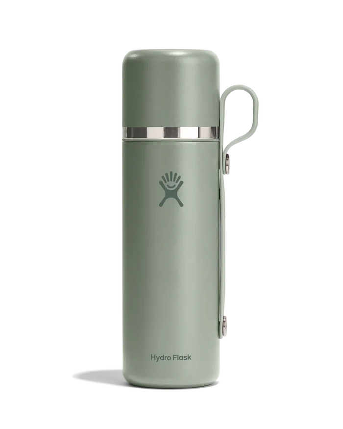 Sage green insulated thermos with cup lid and handle attachment, studio shot on white background