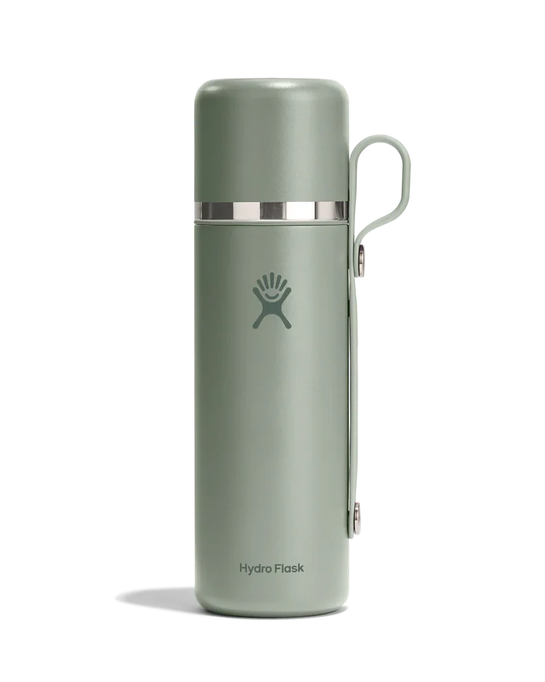 Sage green insulated thermos with cup lid and handle attachment, studio shot on white background