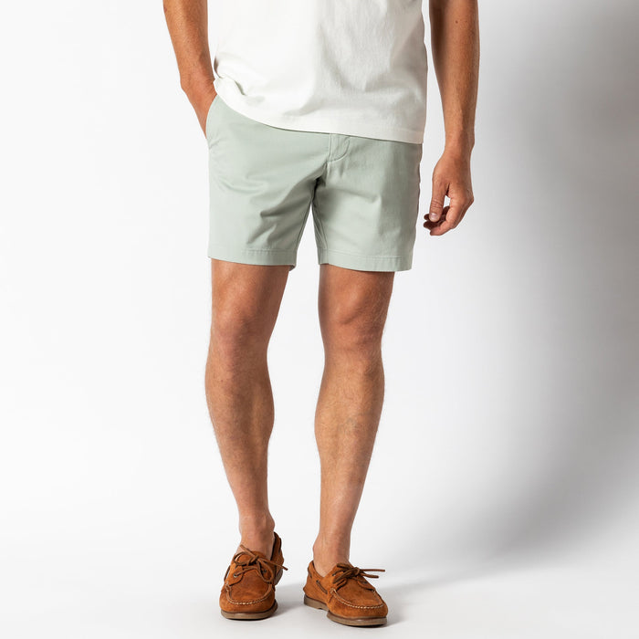 Light green chino shorts worn with white t-shirt and brown boat shoes