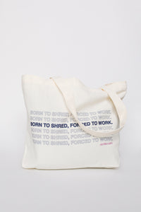 Natural canvas tote bag with repeated 'Born to Shred, Forced to Work' text print, front view