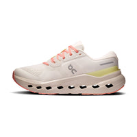 Women's running shoe in off-white with coral laces, yellow heel accent, and chunky cushioned sole, lateral view