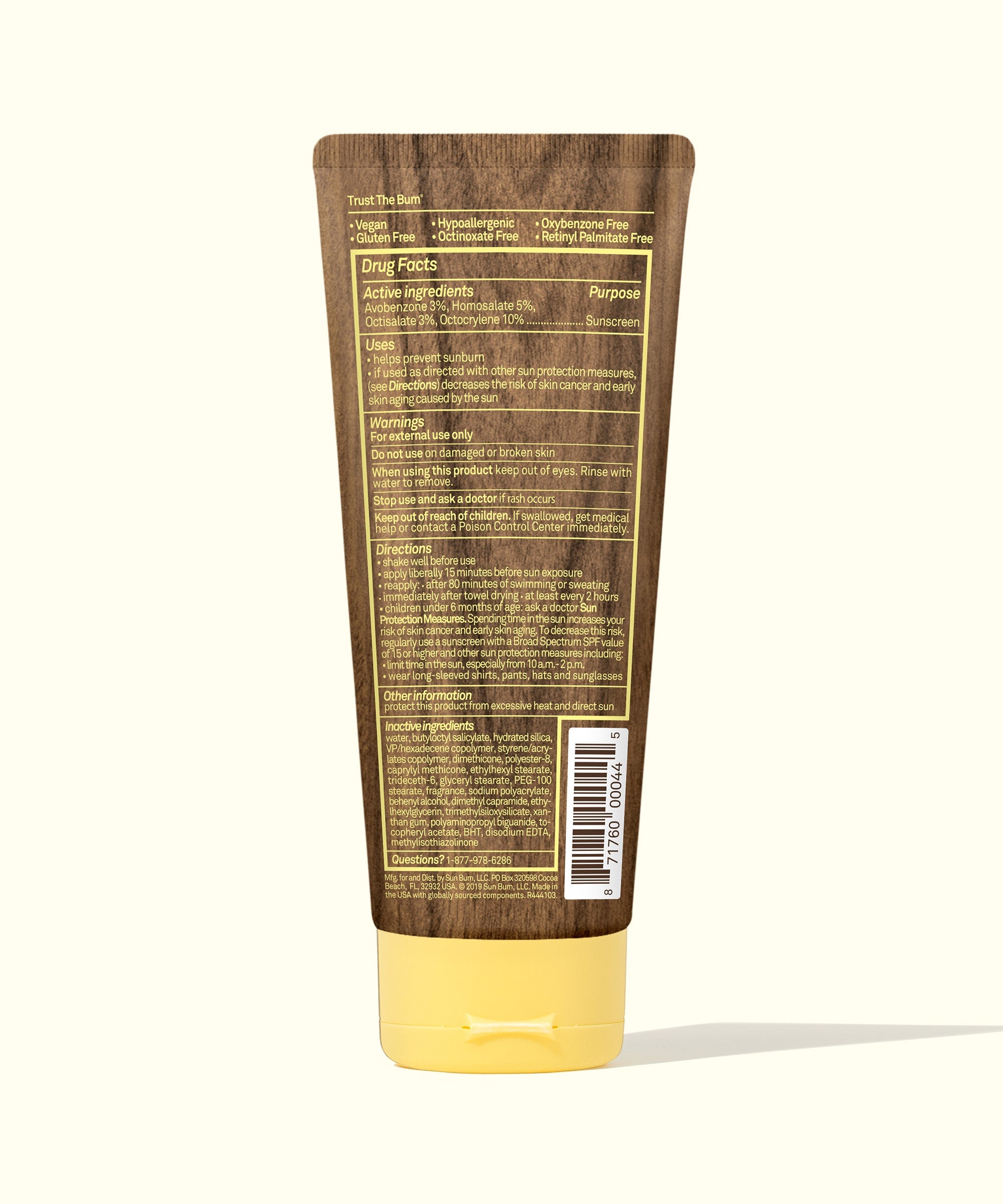 Sunscreen lotion tube with brown packaging and yellow cap showing back label with drug facts