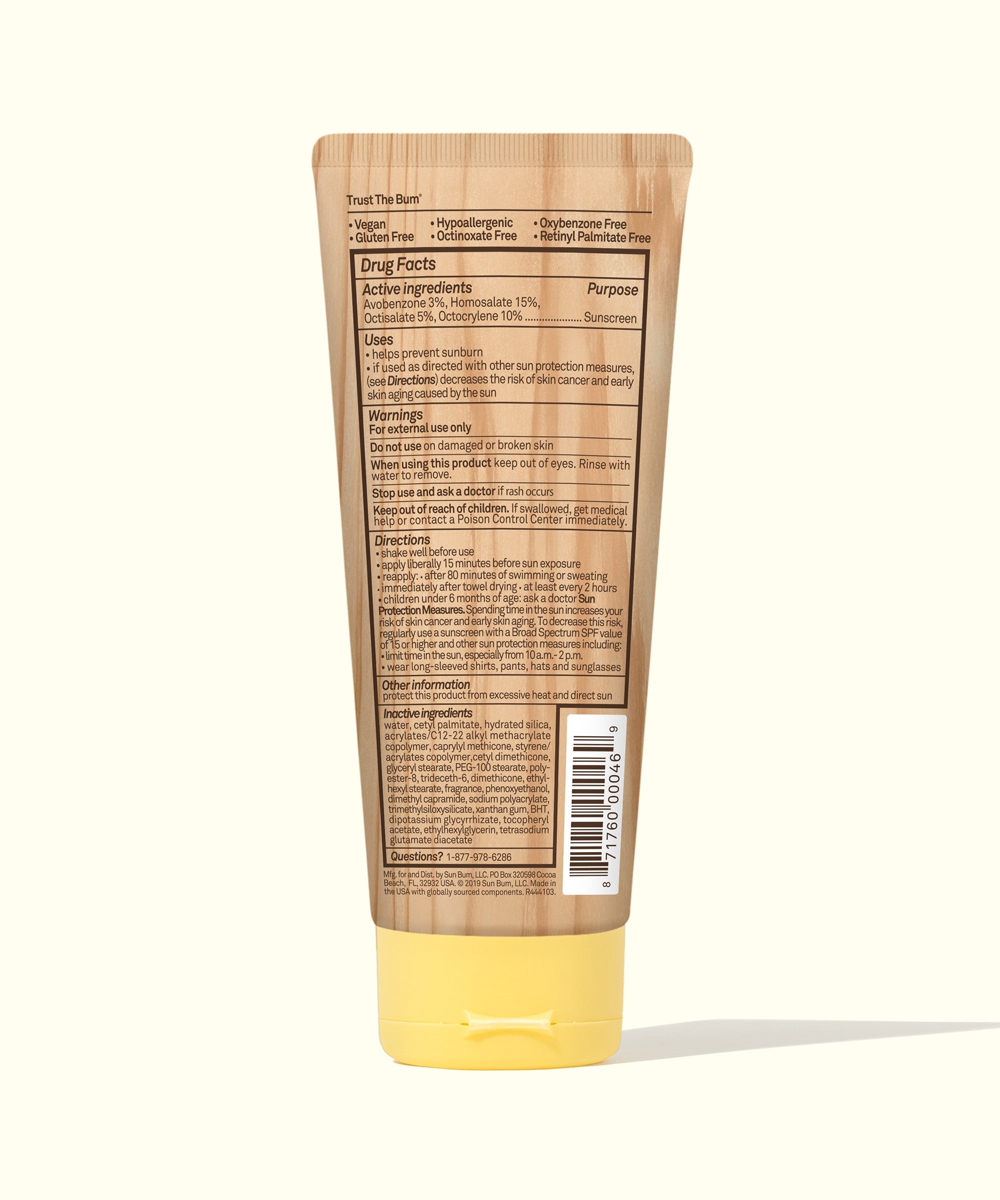 Sunscreen lotion tube with brown body and yellow cap showing back label with ingredients