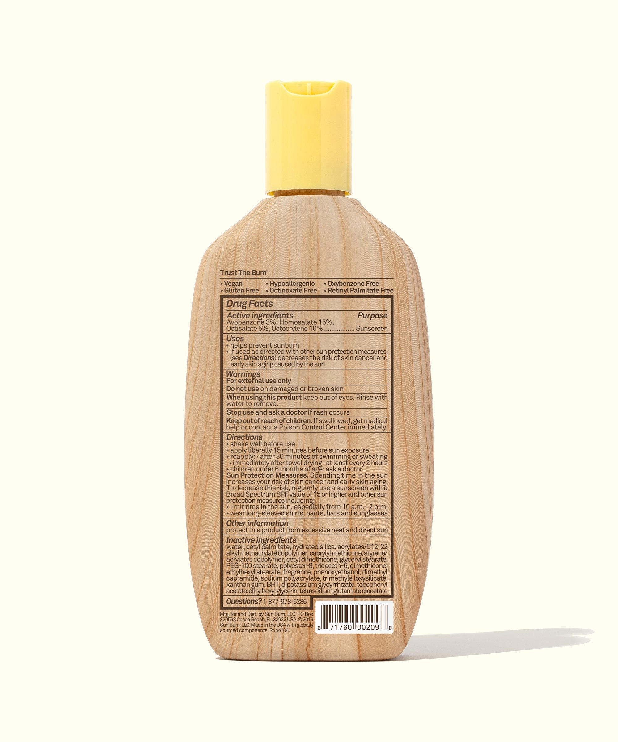 Sunscreen lotion bottle with yellow cap showing back label with ingredients and directions